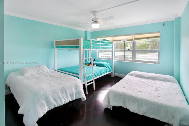 bedroom with ceiling fan, dark hardwood / wood-style floors, and crown molding