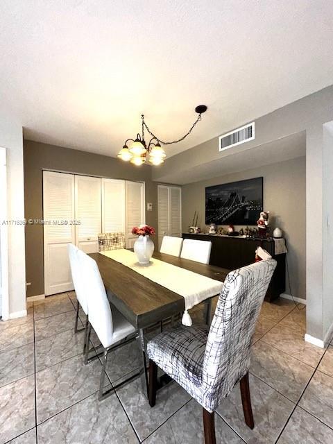 dining area with an inviting chandelier