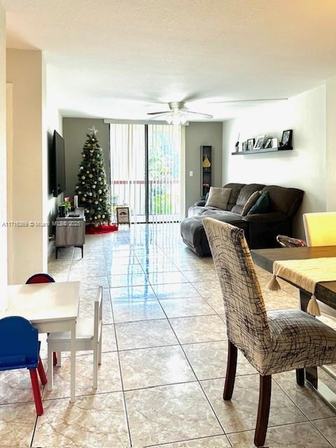 tiled living room with ceiling fan