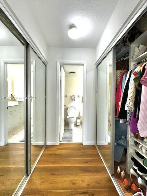 interior space with a textured ceiling and hardwood / wood-style flooring