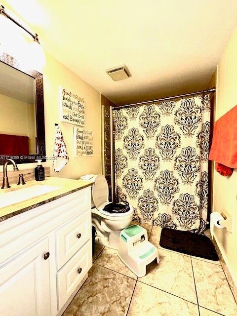 bathroom featuring vanity and toilet