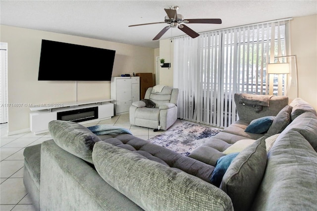 tiled living room featuring ceiling fan and a textured ceiling