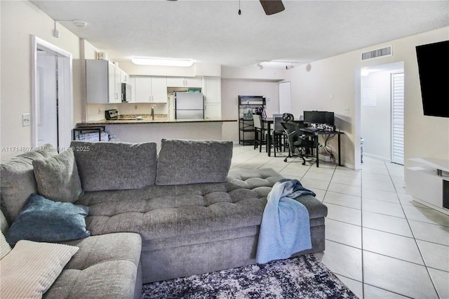 tiled living room with ceiling fan