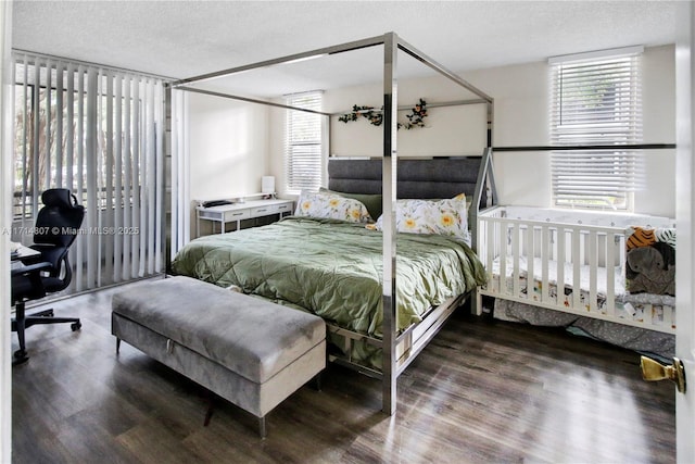 bedroom featuring wood-type flooring and a textured ceiling