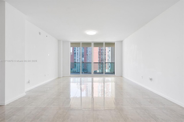 3340 NE 190th St Unit 1206, Aventura, FL 33180 - unfurnished room featuring baseboards and a wall of windows
