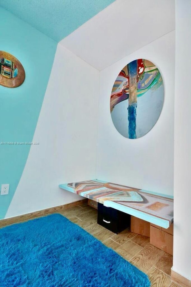 7801 NE 4th Ct Unit 317, Miami, FL 33138 - unfurnished bedroom featuring wood finished floors and baseboards