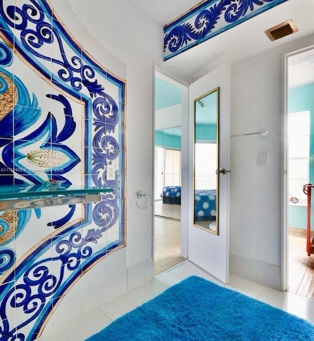 bathroom with tile patterned flooring and french doors