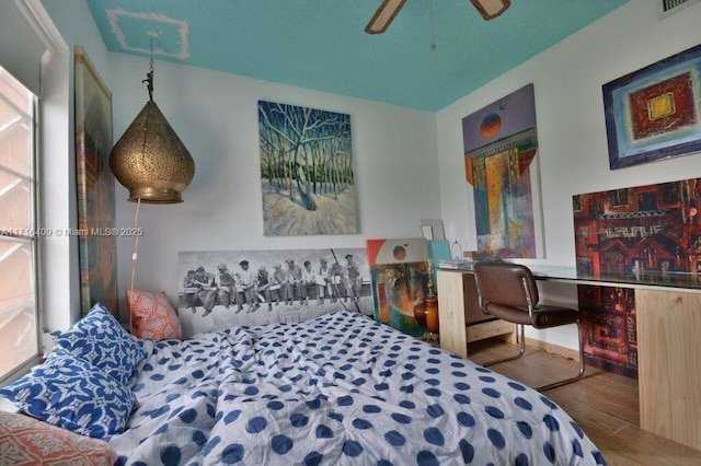 bedroom with hardwood / wood-style floors and ceiling fan