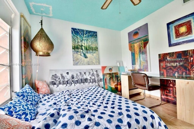 bedroom featuring ceiling fan and hardwood / wood-style flooring