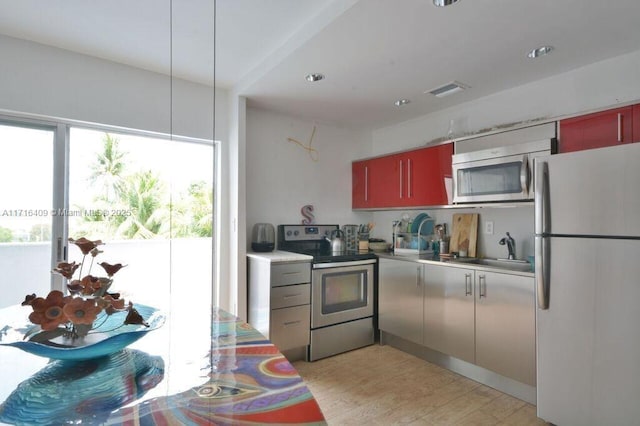 kitchen featuring appliances with stainless steel finishes, light hardwood / wood-style floors, and sink