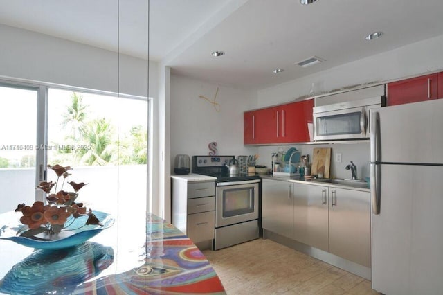 7801 NE 4th Ct Unit 317, Miami, FL 33138 - kitchen with stainless steel appliances, light wood-style flooring, light countertops, and recessed lighting