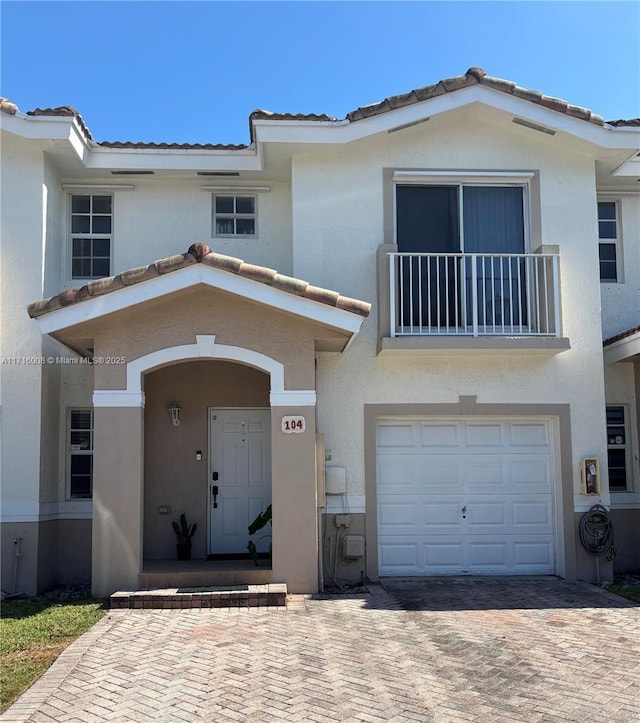 view of front of home featuring a garage and a balcony