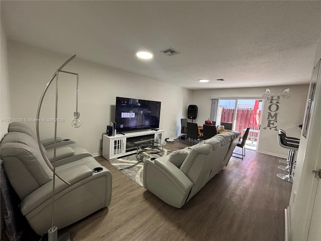 living room with hardwood / wood-style floors and a textured ceiling