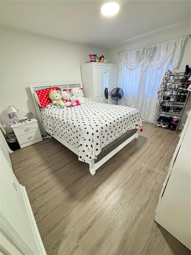 bedroom with hardwood / wood-style flooring