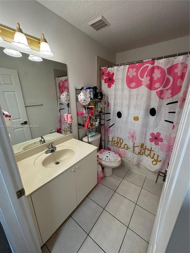 full bathroom with tile patterned floors, toilet, shower / bath combination with curtain, a textured ceiling, and vanity