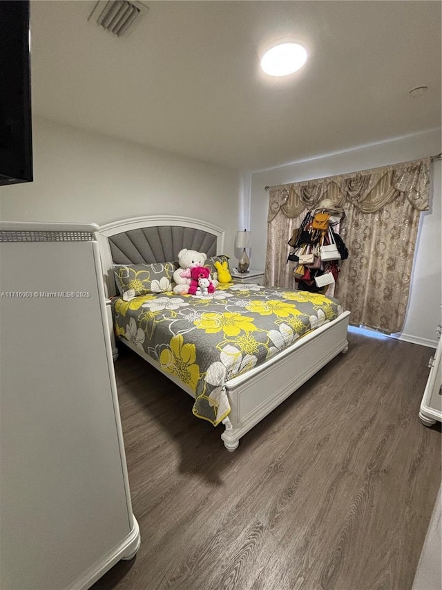 bedroom with dark wood-type flooring