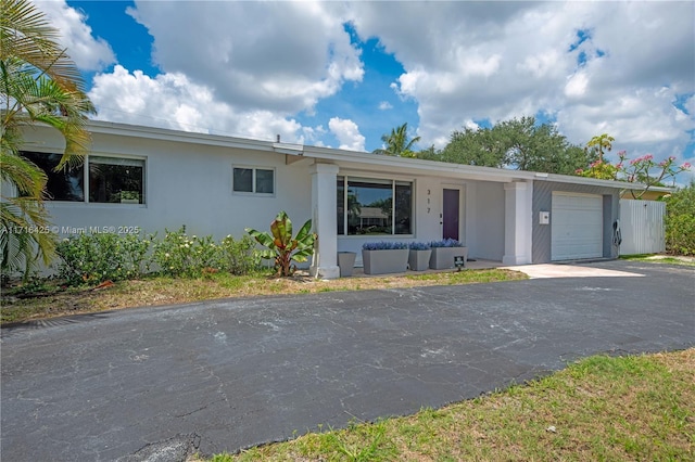 ranch-style home featuring a garage