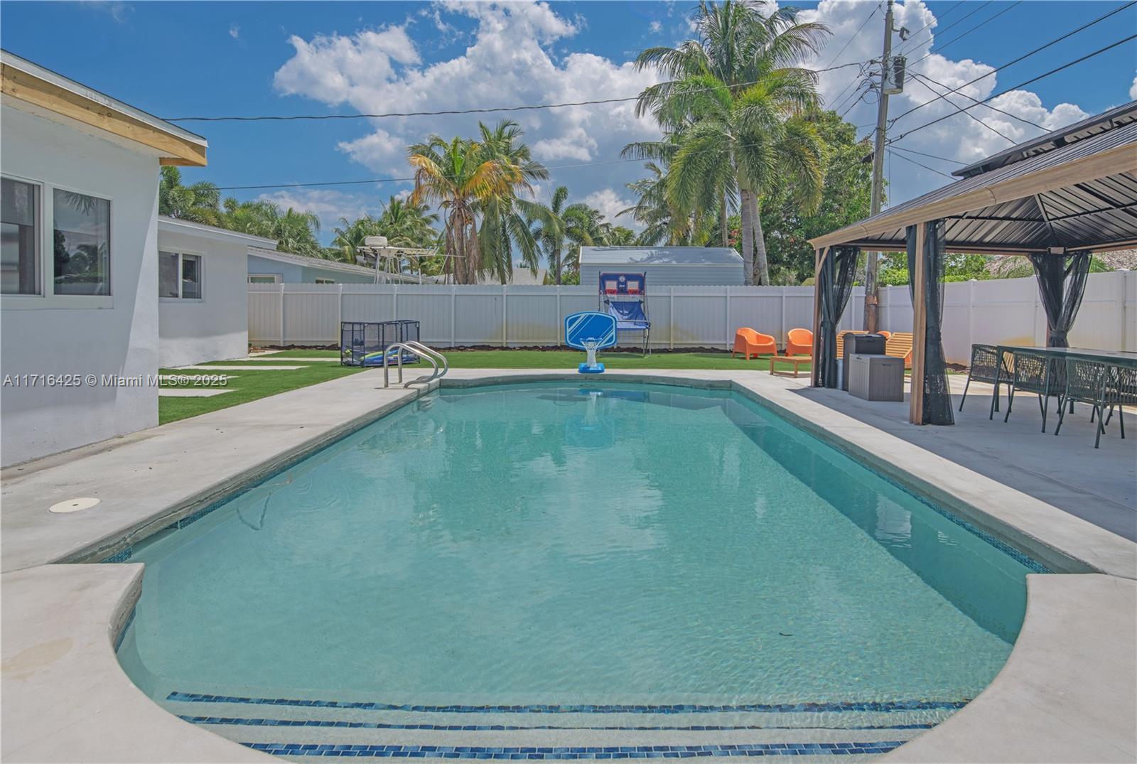 view of swimming pool with a gazebo and a patio