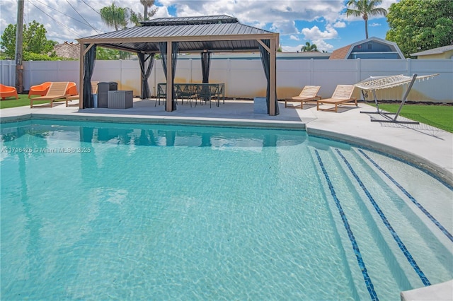 view of swimming pool with a gazebo and a patio