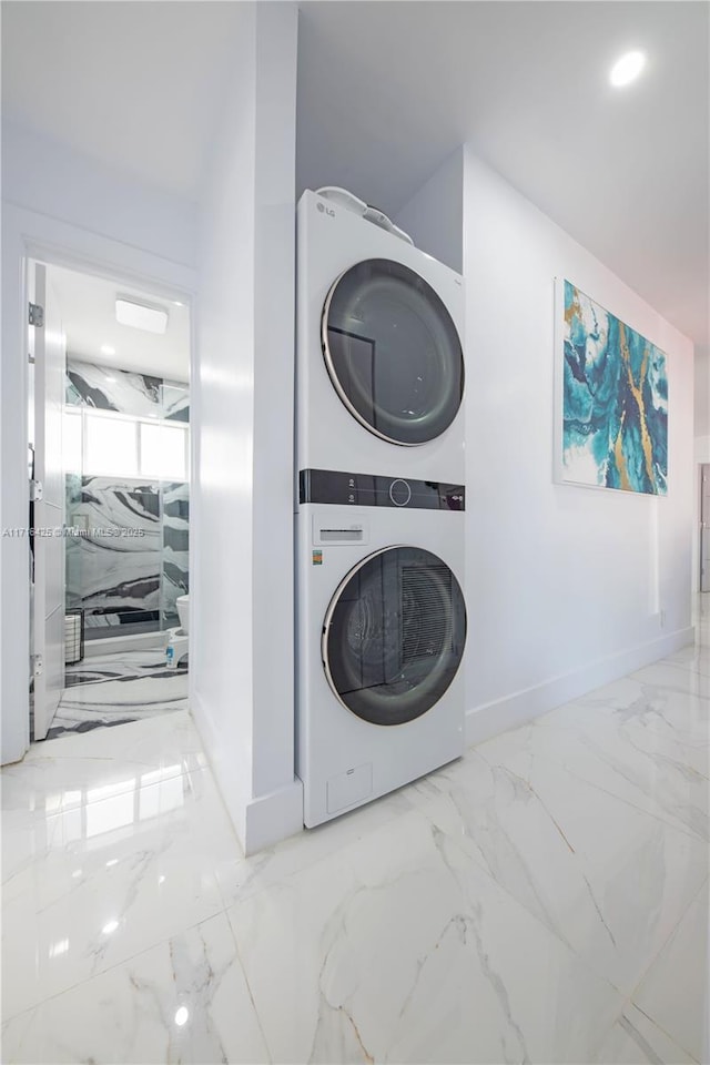 laundry room featuring stacked washer and clothes dryer