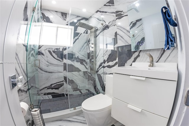 bathroom with vanity, decorative backsplash, toilet, walk in shower, and tile walls