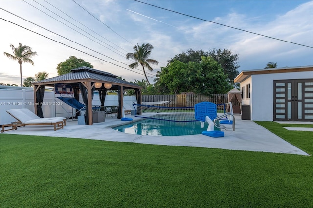 view of swimming pool with a gazebo, a yard, a patio, and an outdoor structure