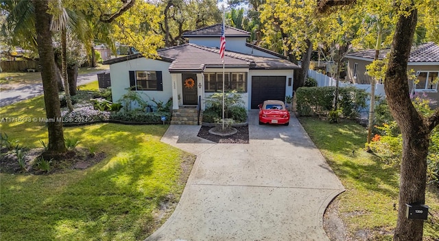 view of front of home featuring a garage and a front lawn