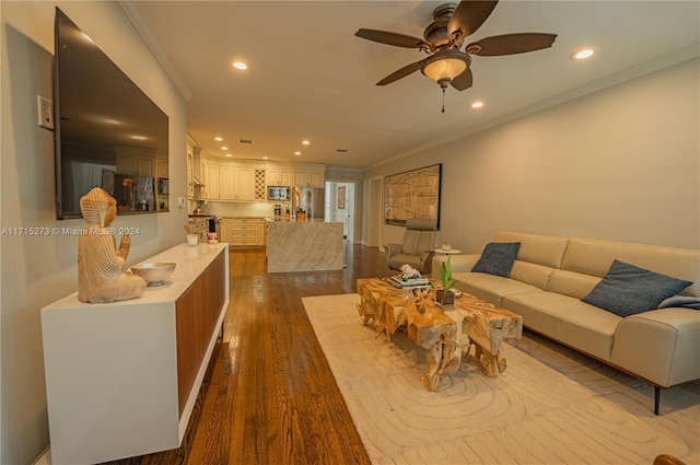 living room featuring ceiling fan, dark wood-type flooring, and ornamental molding