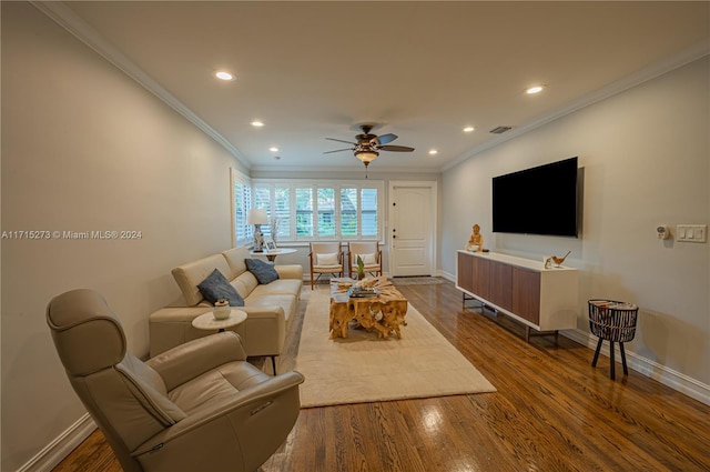 living room with dark wood-type flooring, ceiling fan, and ornamental molding