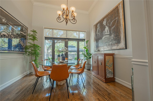 dining space with crown molding, dark wood-type flooring, and a notable chandelier