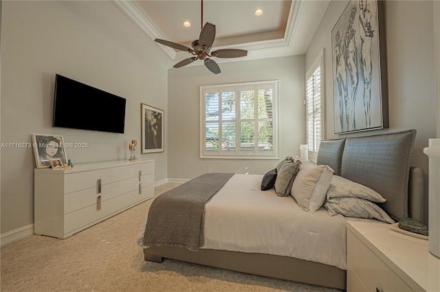 carpeted bedroom featuring a raised ceiling and ceiling fan