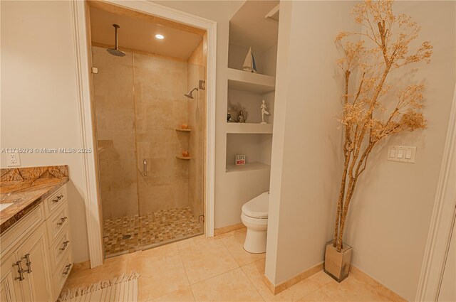 bathroom with tile patterned flooring, vanity, and toilet