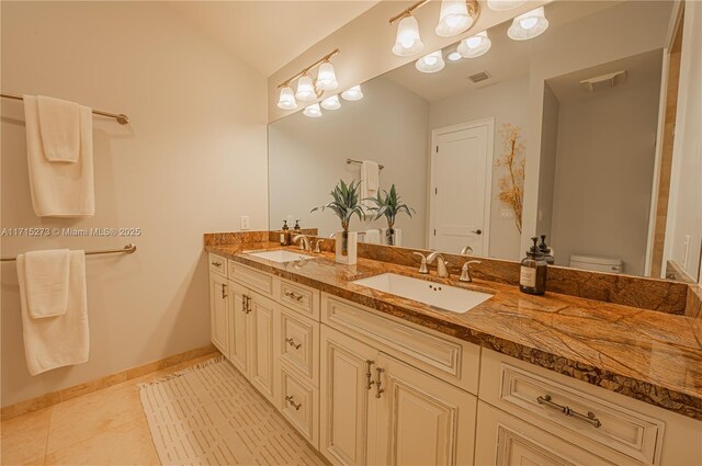 bathroom featuring tile patterned flooring, vanity, and a shower with shower door