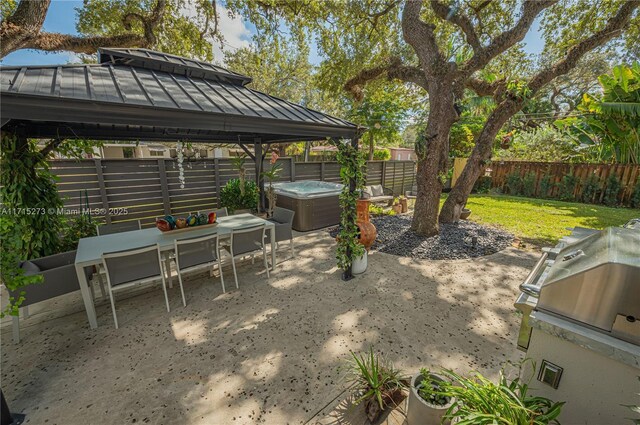 view of patio / terrace with a gazebo and a hot tub