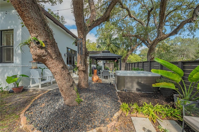 view of yard with a gazebo, a patio, and a hot tub