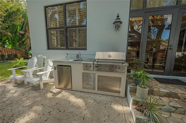 view of patio featuring area for grilling, a grill, and sink