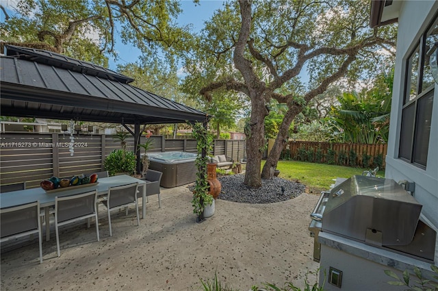 view of patio featuring a gazebo, area for grilling, and a hot tub