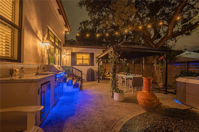 view of patio featuring exterior kitchen, a grill, and an outdoor bar