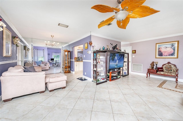 tiled living room with ceiling fan with notable chandelier and ornamental molding