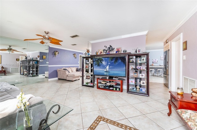 tiled living room with ceiling fan and crown molding