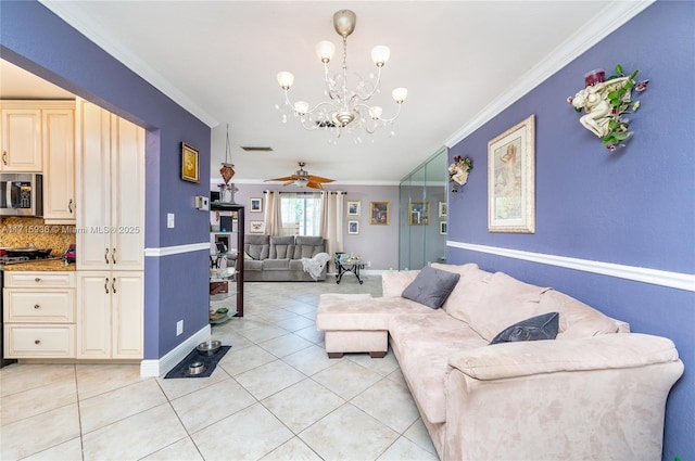 tiled living room with ceiling fan with notable chandelier and ornamental molding