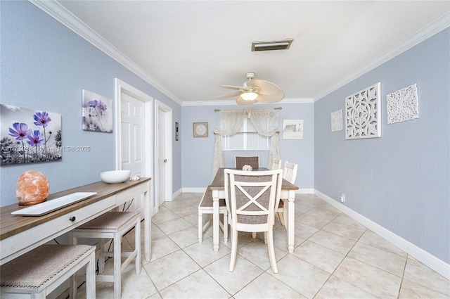 dining room featuring ceiling fan, ornamental molding, and light tile patterned flooring