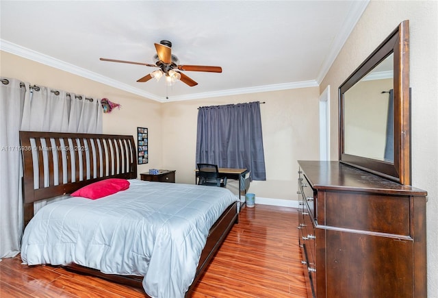 bedroom featuring ceiling fan, crown molding, and light hardwood / wood-style flooring