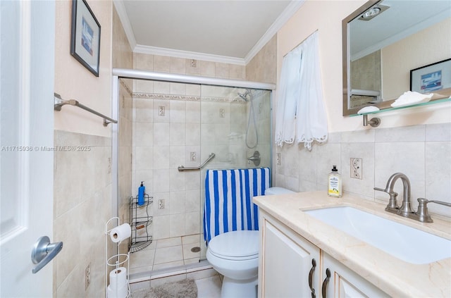 bathroom featuring toilet, vanity, a shower with shower door, tile walls, and ornamental molding