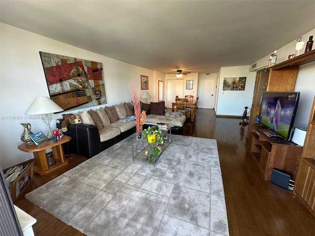 living room featuring hardwood / wood-style floors and ceiling fan