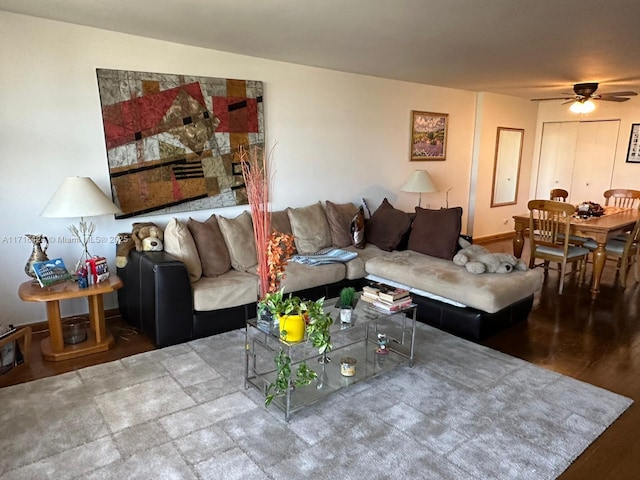 living room with wood-type flooring and ceiling fan