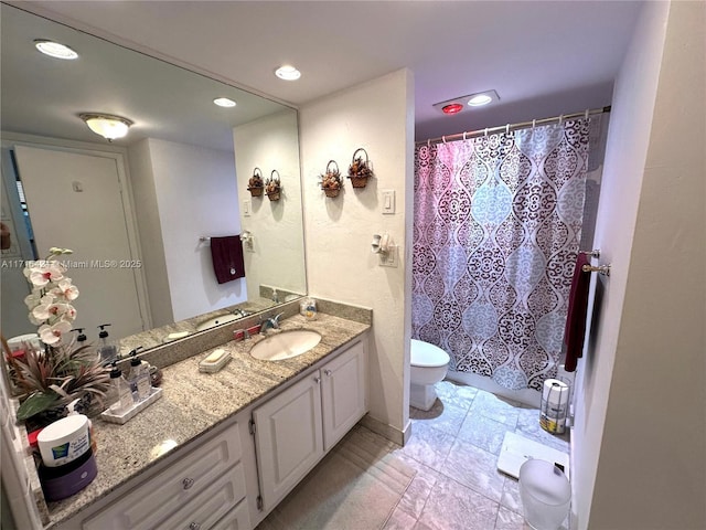 bathroom with vanity and toilet