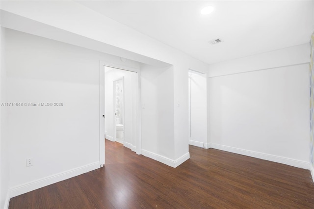 empty room with dark wood-type flooring