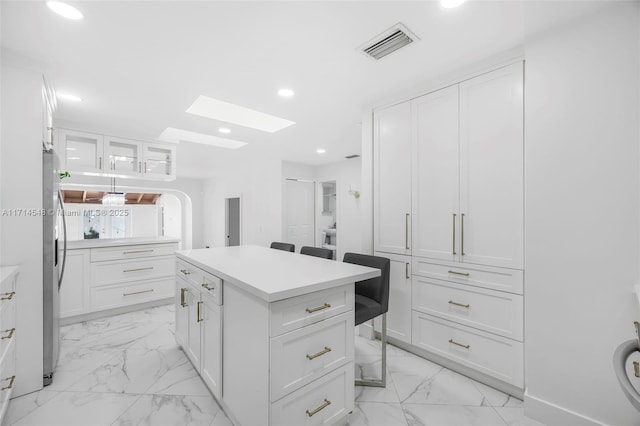 walk in closet featuring a skylight