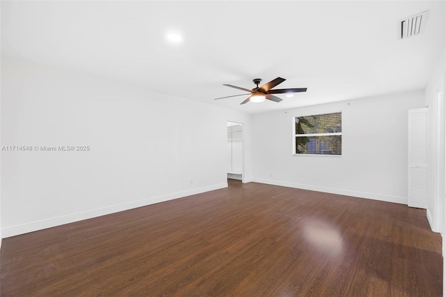 spare room with ceiling fan and dark hardwood / wood-style flooring